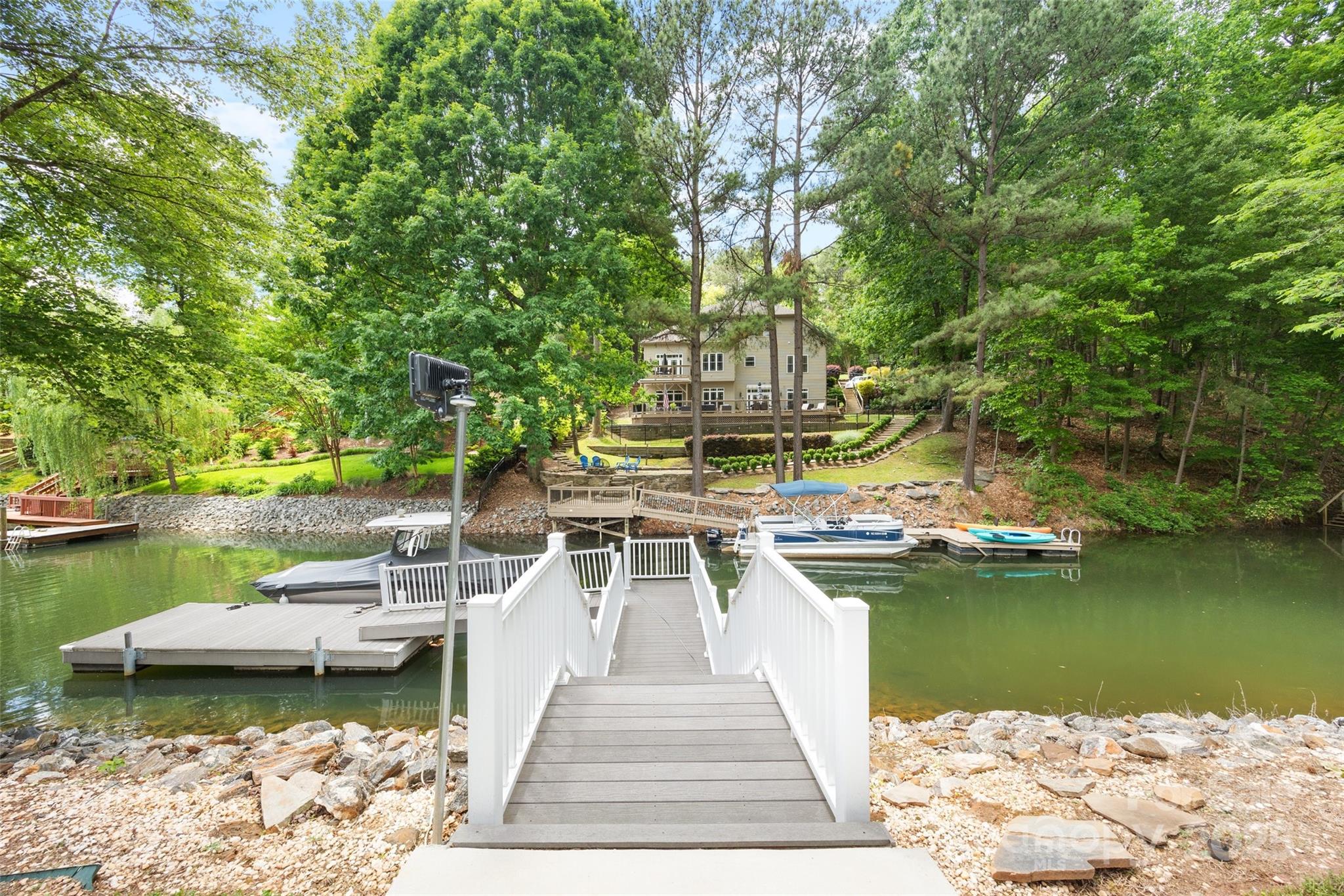 184 Quiet Cove Road Mooresville, NC 28117 - Photo 42 of 45 a view of a ocean with boats and trees in the background