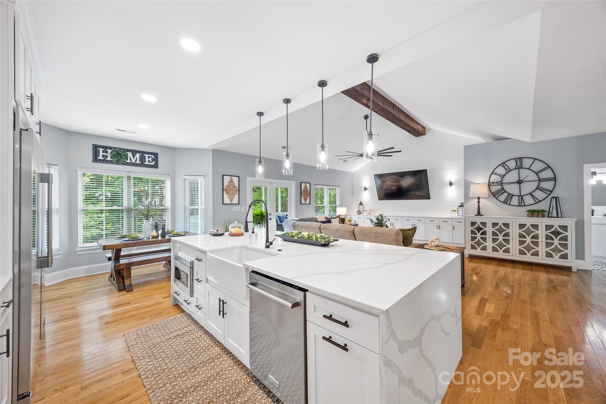 184 Quiet Cove Road Mooresville, NC 28117 - Photo 8 of 45 a large white kitchen with a large window a sink and stainless steel appliances