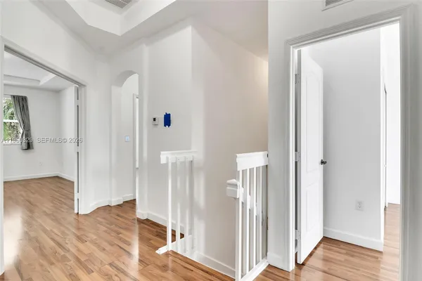 a view of empty room with wooden floor