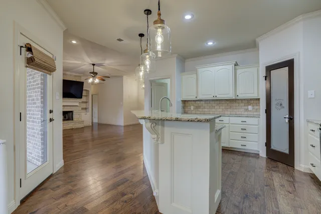 a kitchen with stainless steel appliances granite countertop a stove refrigerator and cabinets