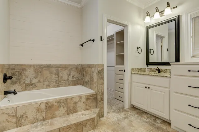 a spacious bathroom with sink shower and mirror