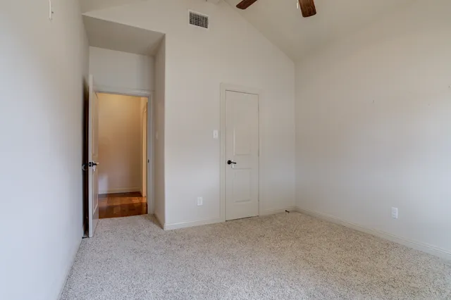a view of an empty room with a closet