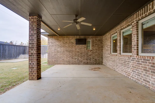a view of a porch with a floor to ceiling window next to a yard