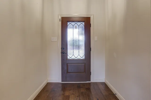 a view of an entryway with wooden floor