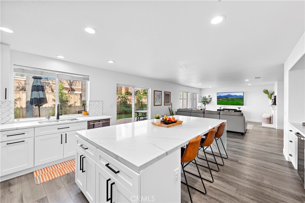 4314 Silver Spring Way Oceanside, CA 92057 - Photo 15 of 47 a kitchen with stainless steel appliances a table and chairs in it