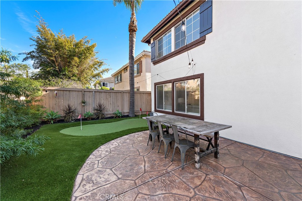 4314 Silver Spring Way Oceanside, CA 92057 - Photo 27 of 47 a backyard of a house with table and chairs