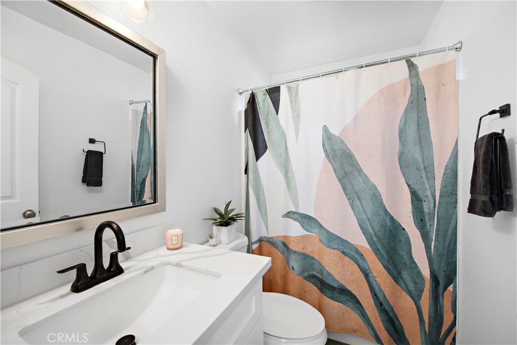 4314 Silver Spring Way Oceanside, CA 92057 - Photo 7 of 47 a bathroom with a sink a toilet and a mirror