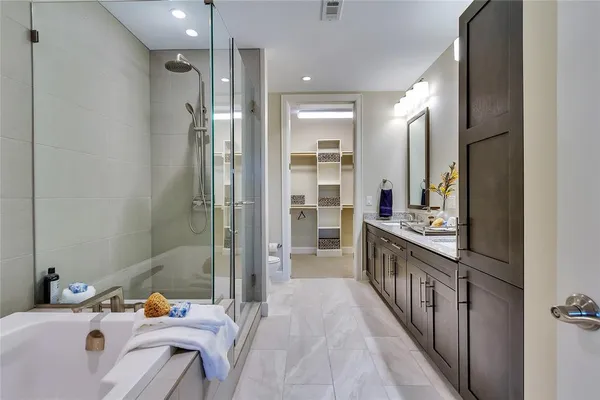 a bathroom with a sink mirror and a bathtub