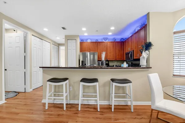 a kitchen with a dining table chairs counter space and cabinets