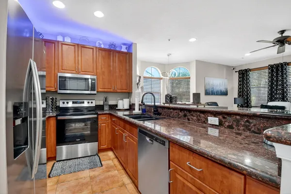 a kitchen with stainless steel appliances a stove sink microwave and cabinets