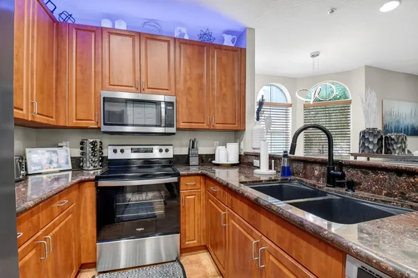 a kitchen with a sink a stove and cabinets