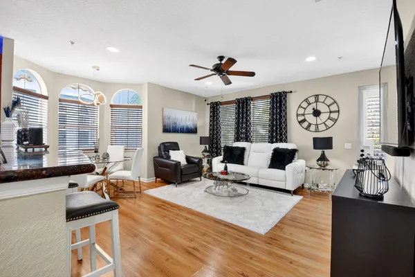 a living room with furniture fireplace and a large window