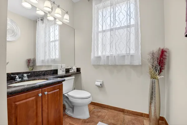 a kitchen with a sink a window and cabinets