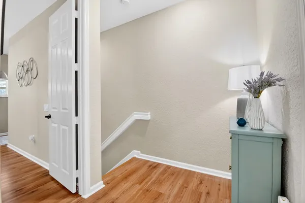 a view of a room with wooden floor and cabinet