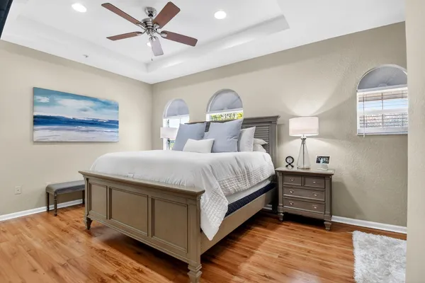 a bedroom with a bed and a chandelier