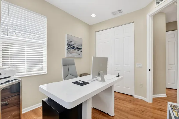 a view of a dining room with a table and chairs