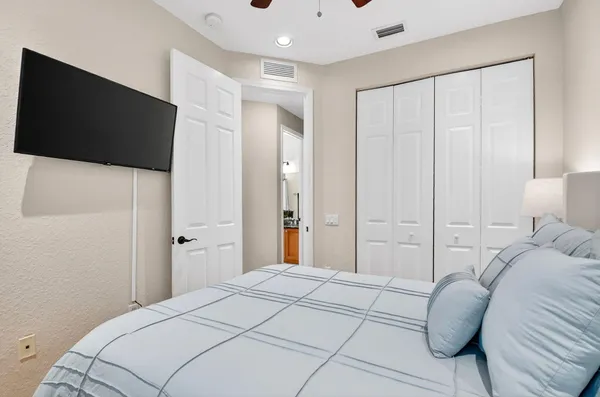 a bedroom with a bed and a flat screen tv