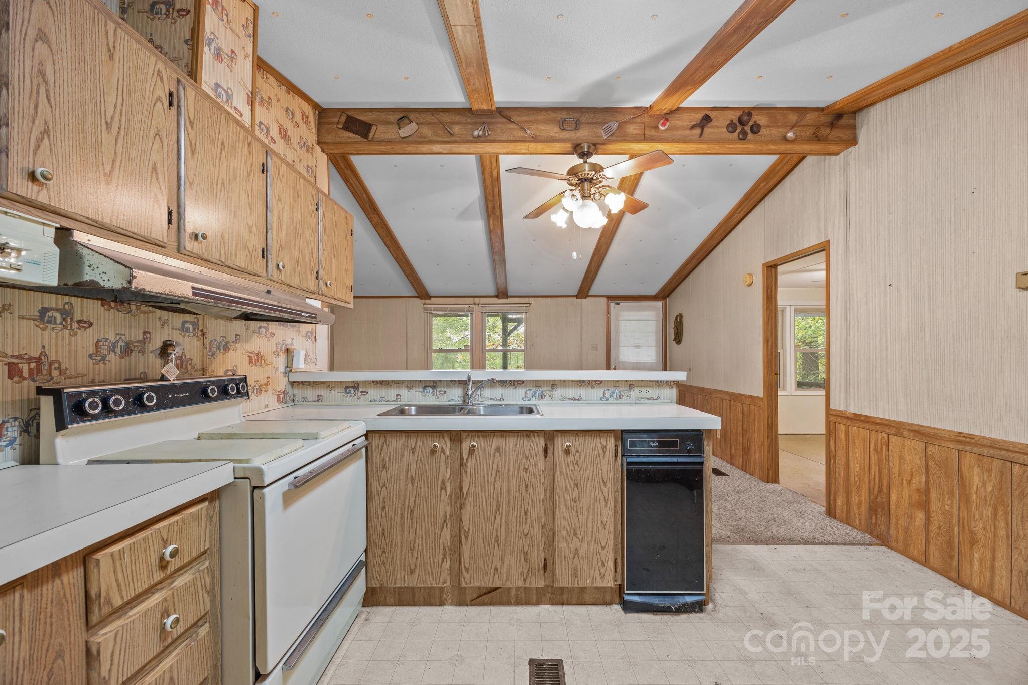 101 Serenity Lane Clyde, NC 28721 - Photo 13 of 26 a kitchen that has a sink a stove and a microwave