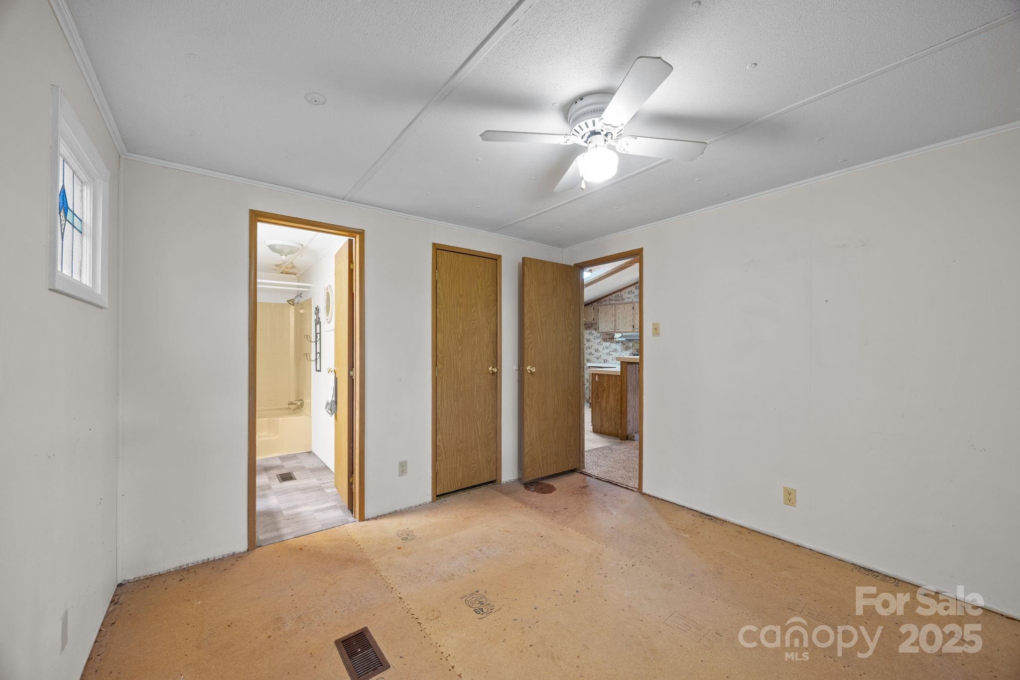 101 Serenity Lane Clyde, NC 28721 - Photo 16 of 26 a view of a livingroom with a ceiling fan and window