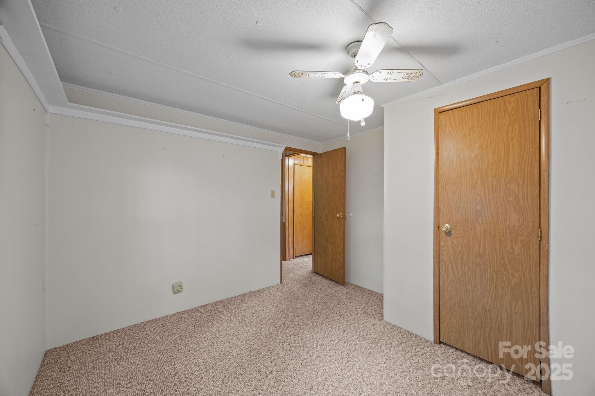 101 Serenity Lane Clyde, NC 28721 - Photo 23 of 26 a view of an empty room with a chandelier fan