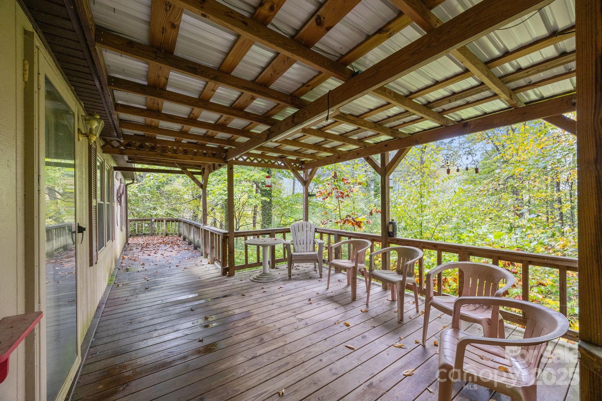 101 Serenity Lane Clyde, NC 28721 - Photo 3 of 26 a view of a chairs and table on the wooden floor