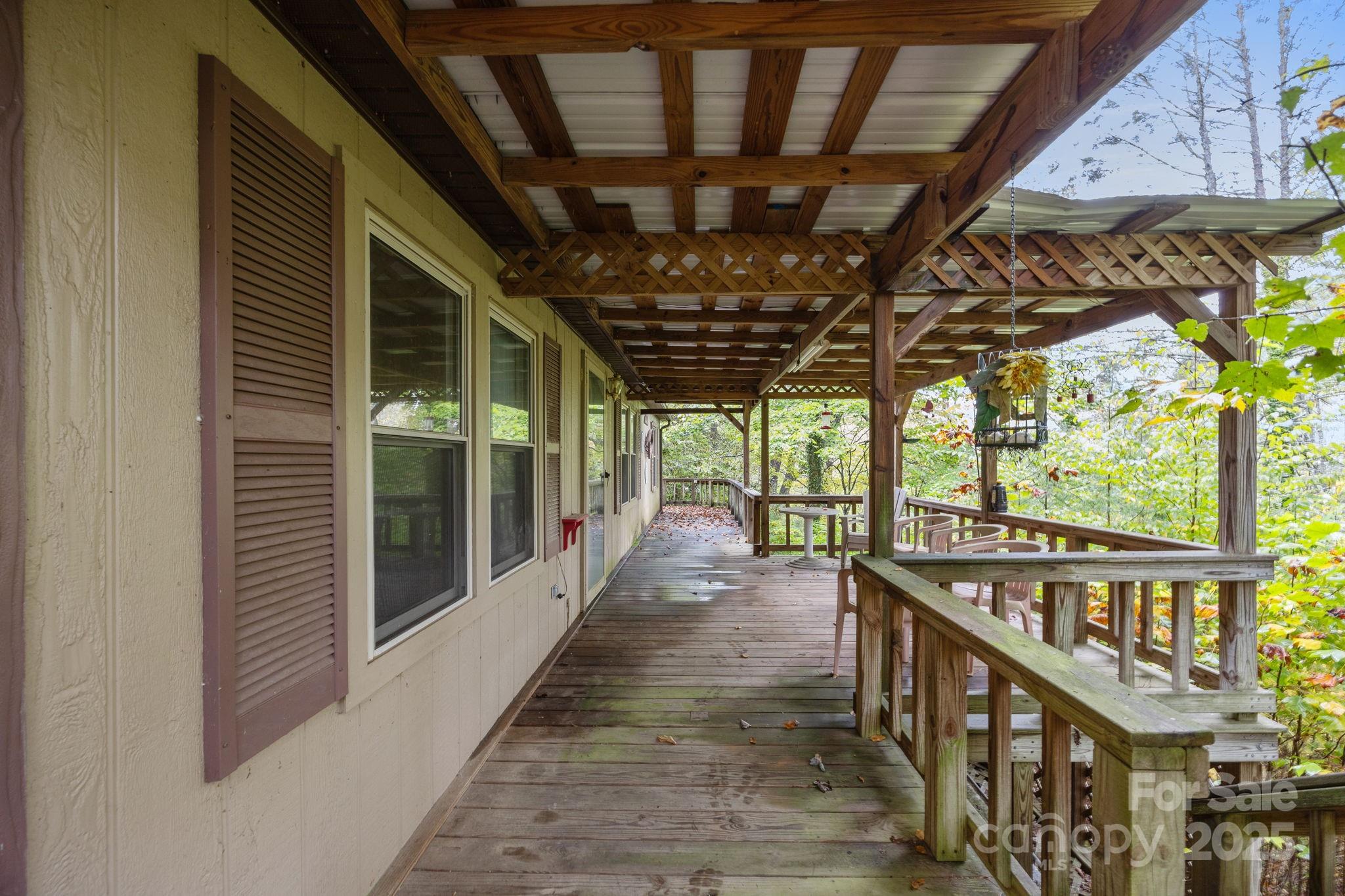101 Serenity Lane Clyde, NC 28721 - Photo 4 of 26 a view of a porch with wooden floor and outdoor space