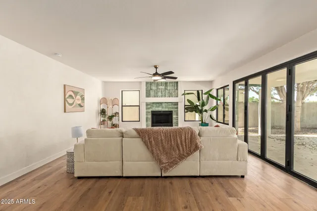 a living room with furniture ceiling fan and a rug