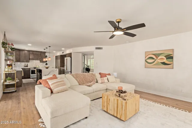 a living room with furniture and a large window with outer view