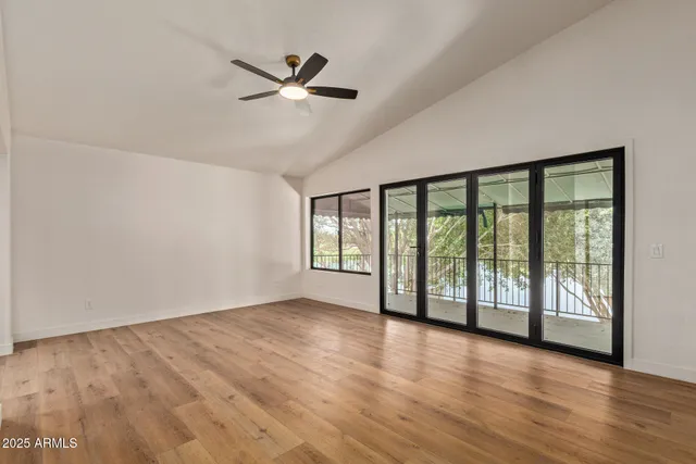 a view of empty room with wooden floor