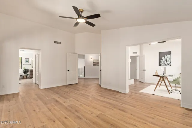 a view of an empty room and window with wooden floor