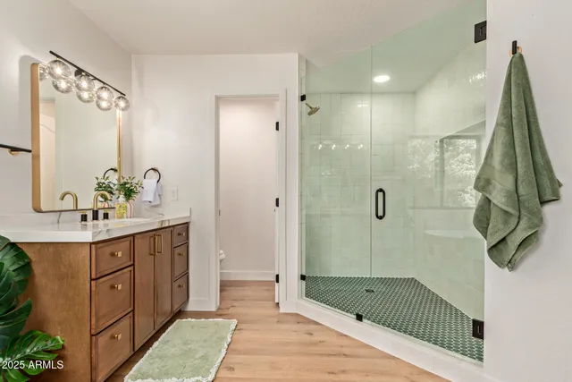 a spacious bathroom with a tub sink and mirror