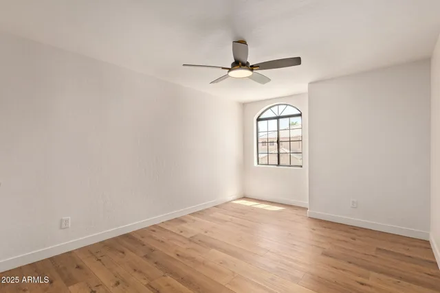 a view of a big room with wooden floor and closet area