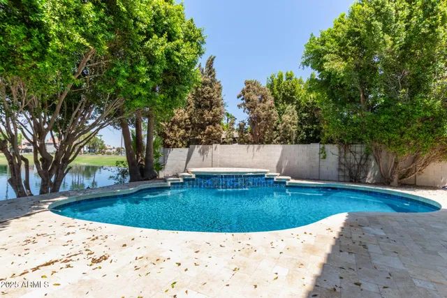 a swimming pool with trees in the background