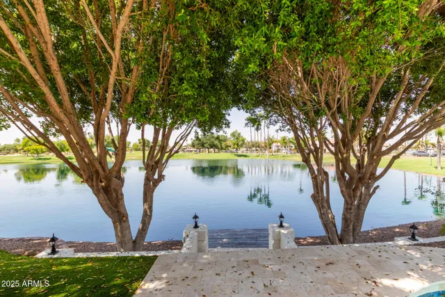 a front view of a house with a garden and trees