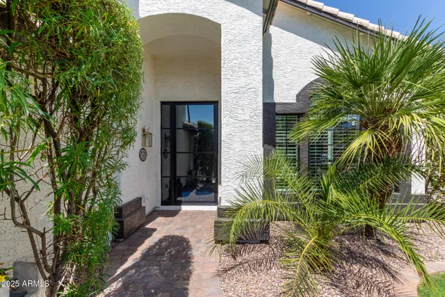 a couple of potted plants in front of door