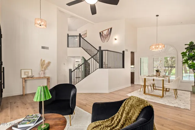a view of a dining room with furniture a chandelier and wooden floor