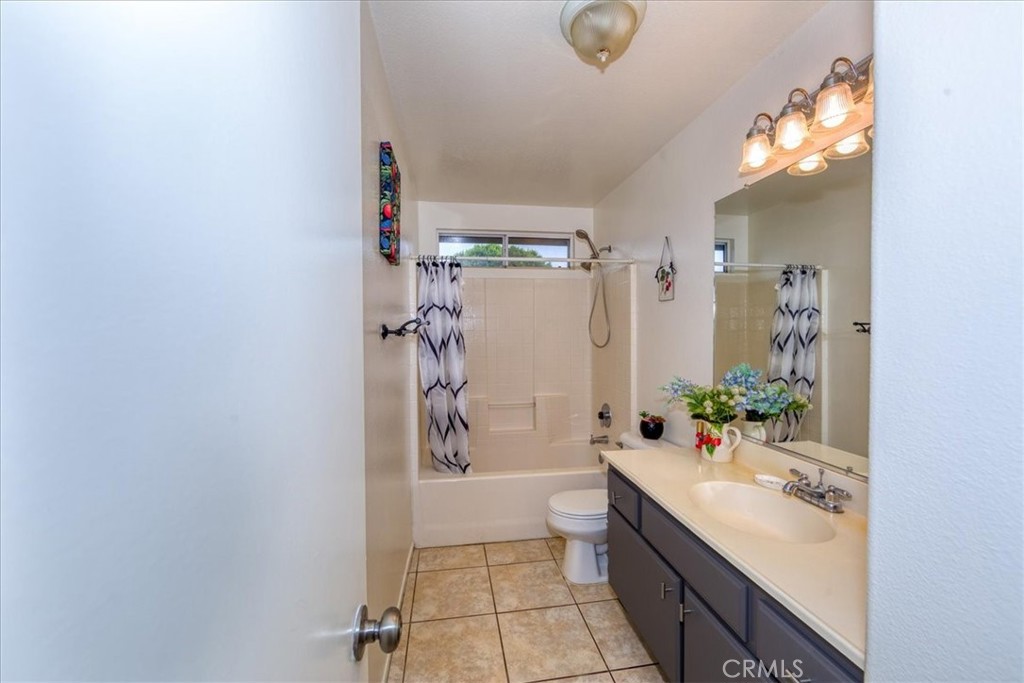 2374 Nash Lane Oxnard, CA 93033 - Photo 12 of 18 a bathroom with a granite countertop sink a toilet and shower