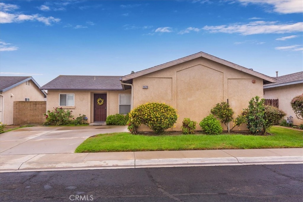 2374 Nash Lane Oxnard, CA 93033 - Photo 2 of 18 a front view of a house with a garden and plants