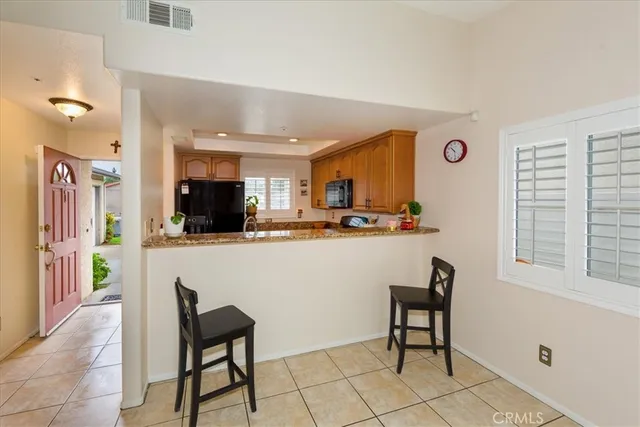a living room with stainless steel appliances kitchen island granite countertop furniture and a window