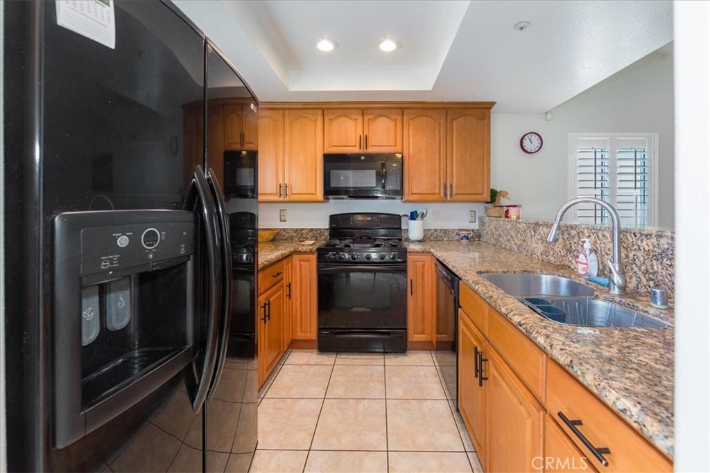 2374 Nash Lane Oxnard, CA 93033 - Photo 7 of 18 a kitchen with stainless steel appliances granite countertop a stove a sink and a microwave