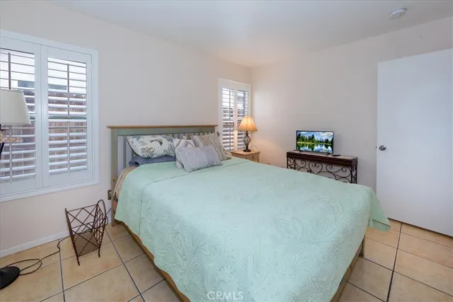 a bed sitting in a bedroom next to a window