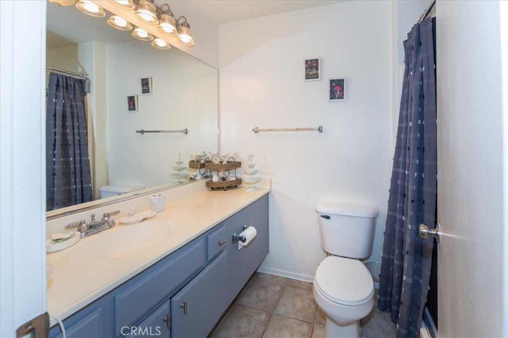 2374 Nash Lane Oxnard, CA 93033 - Photo 10 of 18 a bathroom with a granite countertop toilet sink and mirror