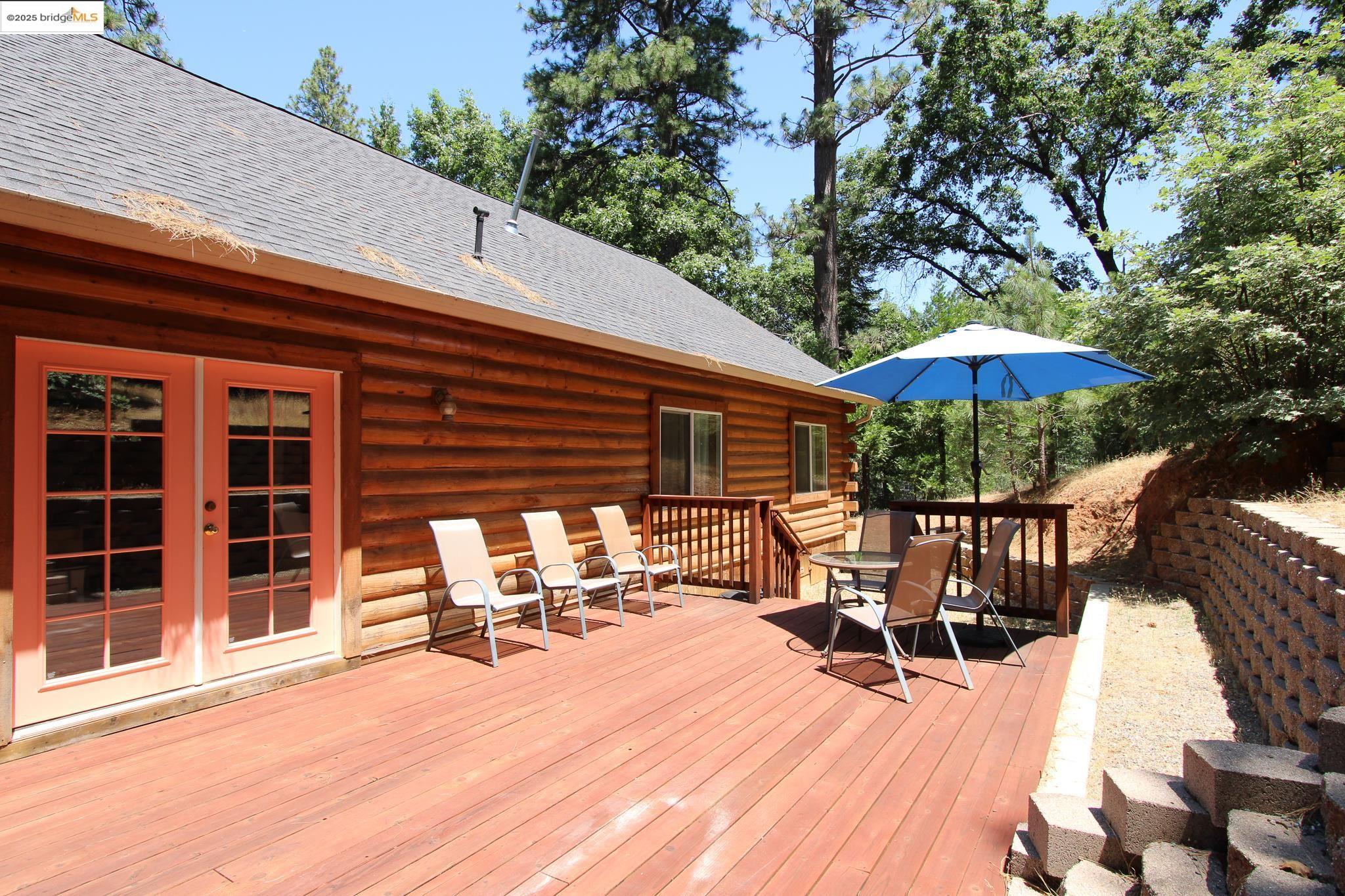 2936 Highway 4 Murphys, CA 95247 - Photo 12 of 41 a view of a patio with a table and chairs under an umbrella with a small yard