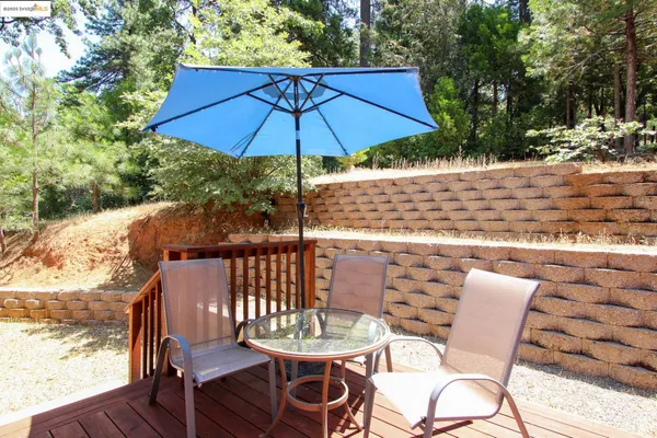 a patio with a patio table and chairs