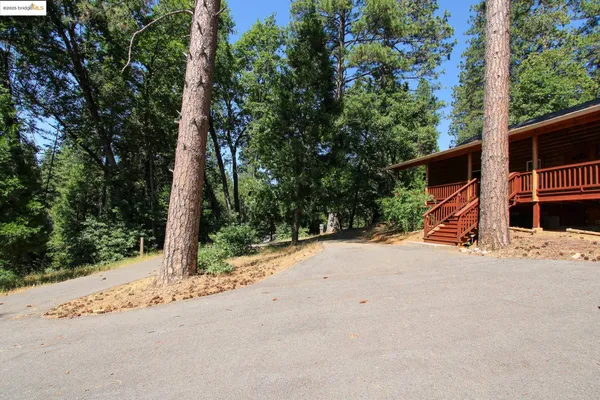 a view of house with outdoor space and sitting area