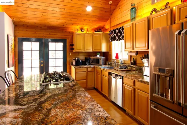 a kitchen with a large window a sink and cabinets