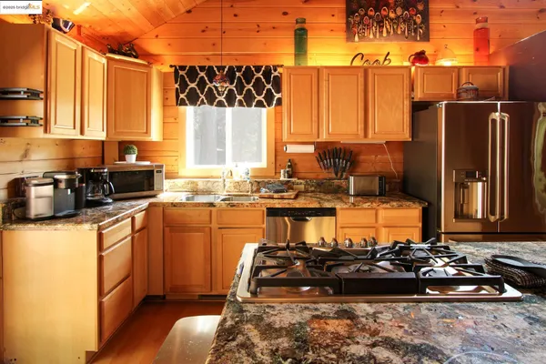 a kitchen with a stove and a chandelier