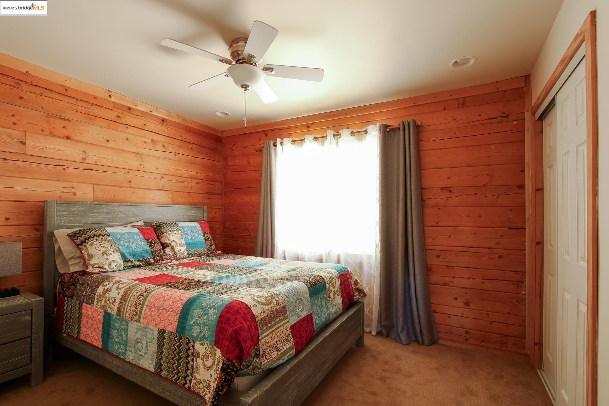 2936 Highway 4 Murphys, CA 95247 - Photo 29 of 41 a bedroom with a bed and a ceiling fan