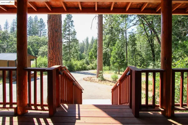 a view of a balcony with wooden floor and outdoor seating