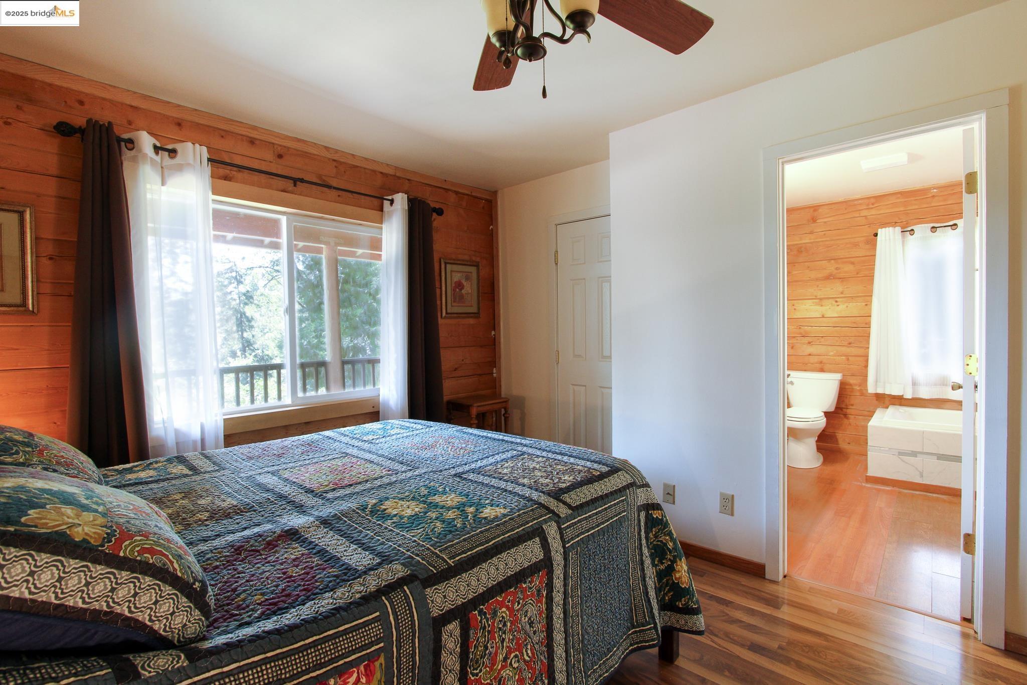 2936 Highway 4 Murphys, CA 95247 - Photo 34 of 41 a bedroom with a bed and wooden floor